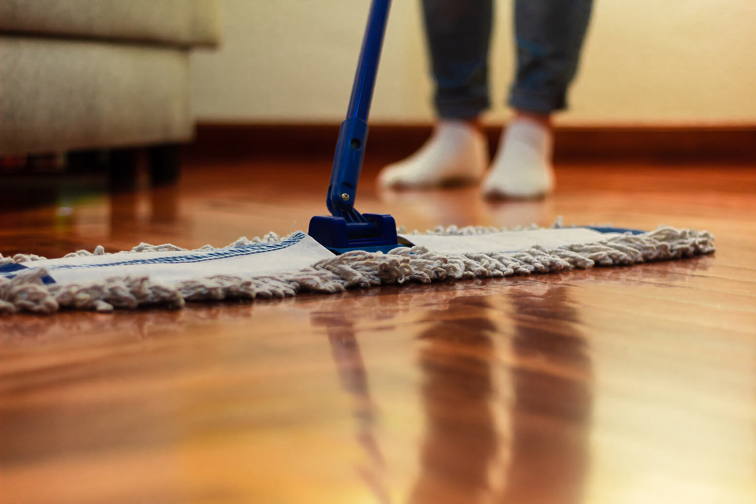 A large professional mop positioned on a hardwood floor